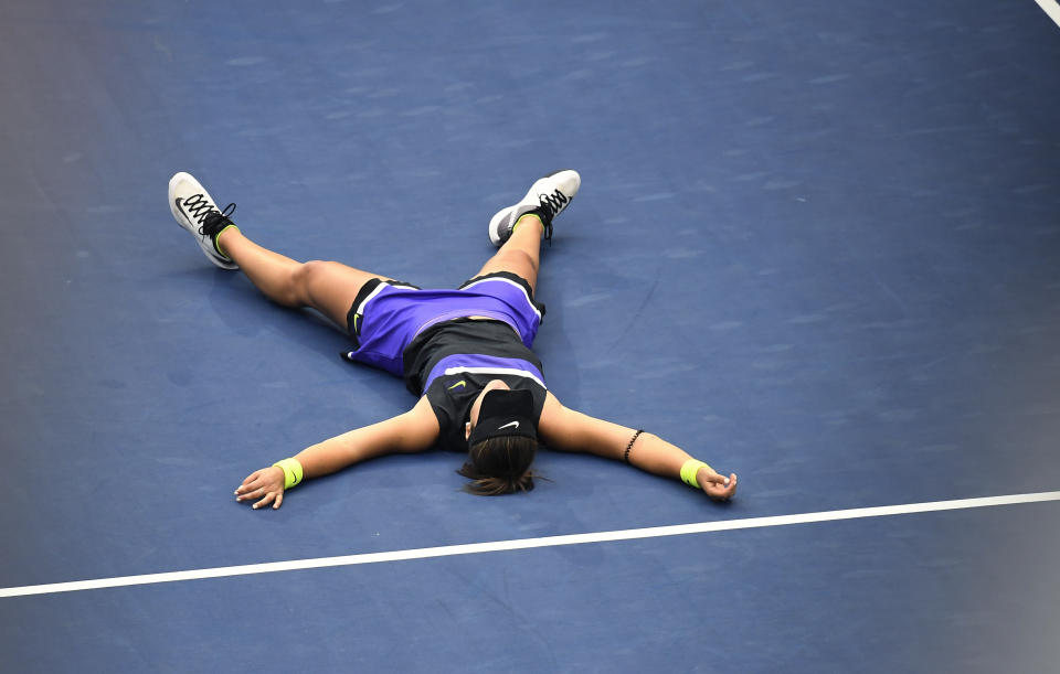 Bianca Andreescu, of Canada, lays on the court after defeating Serena Williams, of the United States, during the women's singles final of the U.S. Open tennis championships Saturday, Sept. 7, 2019, in New York. (AP Photo/Sarah Stier)