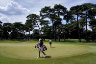 Albane Valenzuela, of Switzerland, and her brother and caddy, Alexis Valenzuela, practice on the 11th green during a practice round prior to the women's golf event at the 2020 Summer Olympics, Monday, Aug. 2, 2021, at the Kasumigaseki Country Club in Kawagoe, Japan. (AP Photo/Matt York)