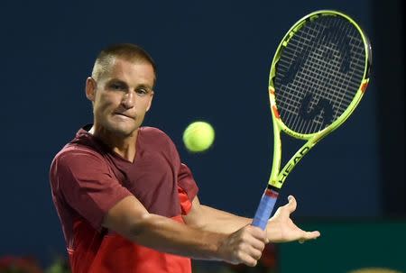 Jul 26, 2016; Toronto, Ontario, Canada; Mikhail Youzhny of Russia hits a shot against Stan Wawrinka of Switzerland on day two of the Rogers Cup tennis tournament at Aviva Centre. Mandatory Credit: Dan Hamilton-USA TODAY Sports