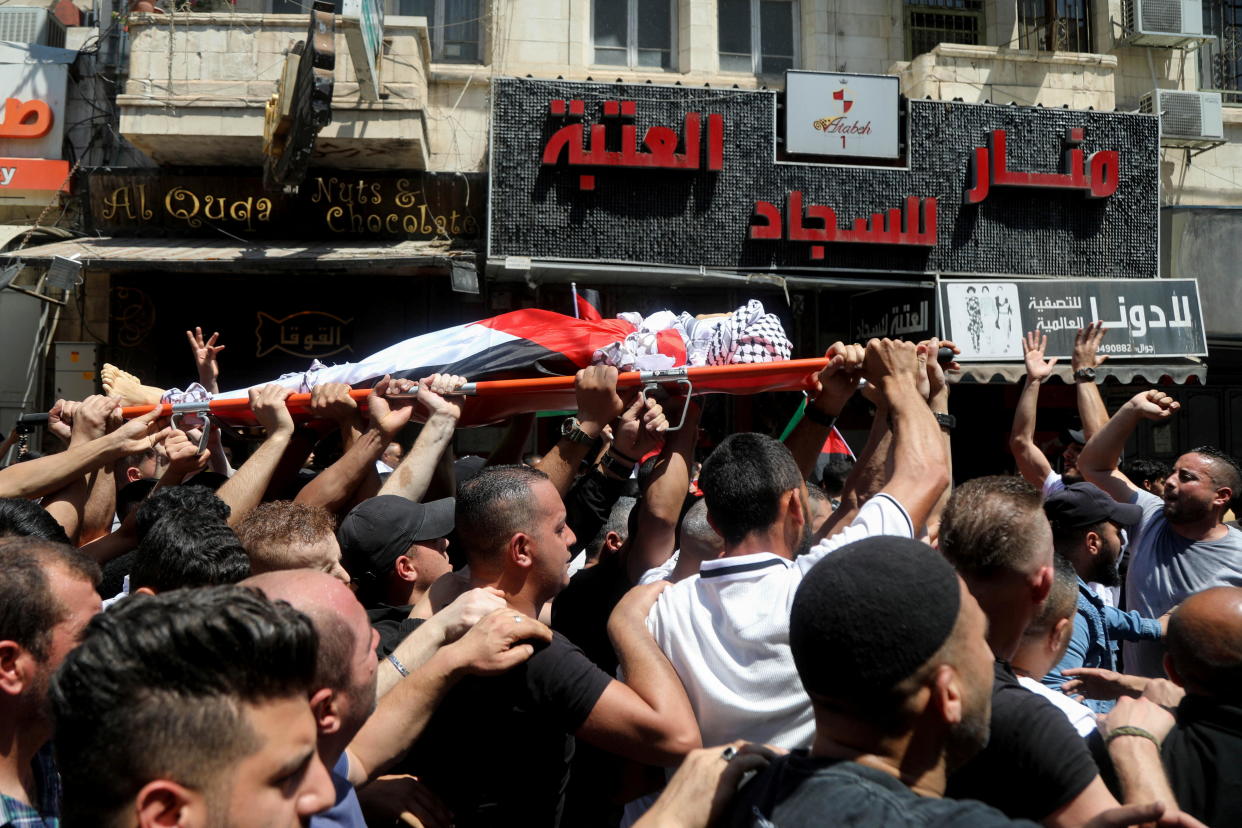 Mourners carry the body of Palestinian teen Ghaith Yamen, who was killed during clashes with Israeli forces, during his funeral in Nablus, in the Israeli-occupied West Bank, May 25, 2022. / Credit: RANEEN SAWAFTA/REUTERS