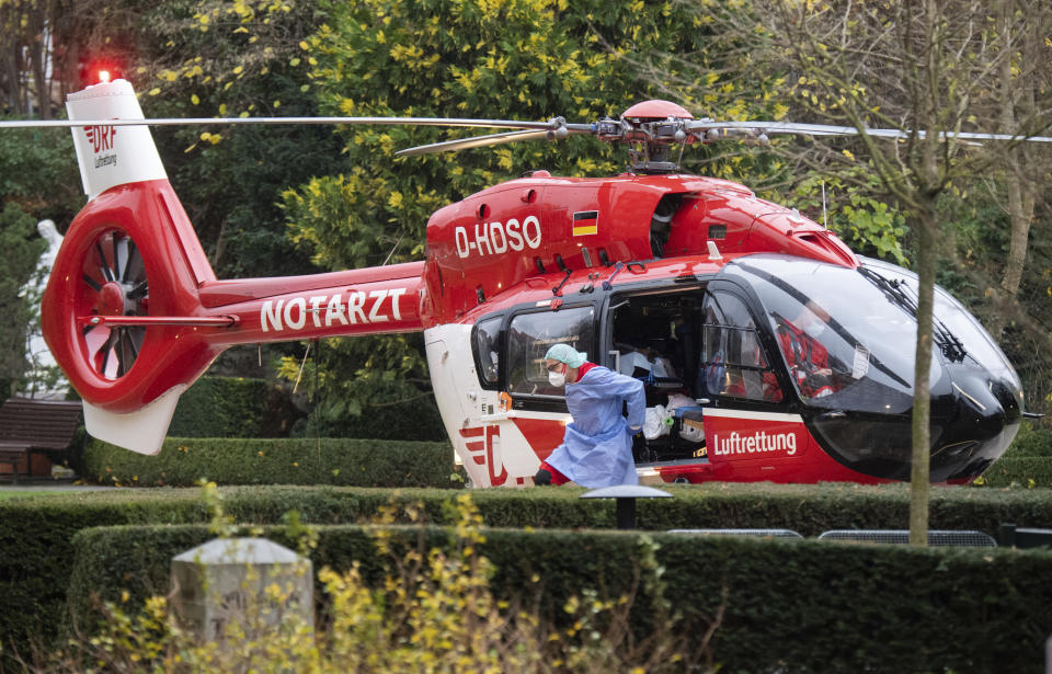 A helicopter of the DRF Luftrettung brings a patient who is seriously ill with the coronavirus and the COVID-19 disease to the St. Bernward Hospital in Hildesheim, Germany, Friday, Nov. 26, 2021. From Bavaria, Thuringia and Saxony, Covid-19 patients are transport to hospitals in the north and west of Germany. (Julian Stratenschulte/dpa via AP)