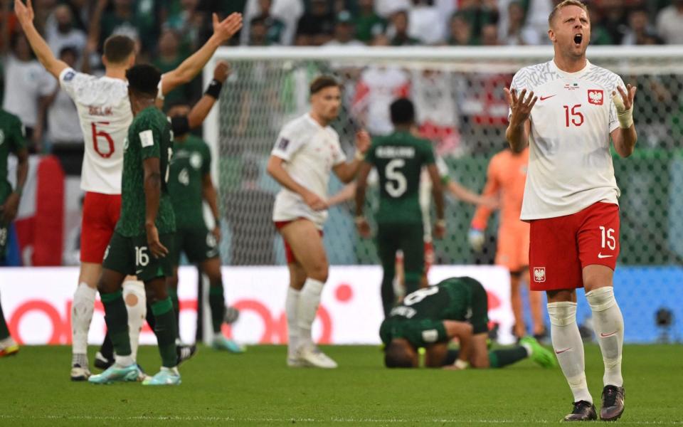 Kamil Glik (R) reacts during the Qatar 2022 World Cup Group C football match between Poland and Saudi Arabia at the Education City Stadium in Al-Rayyan, west of Doha on November 26, 2022. - ANDREJ ISAKOVIC/AFP via Getty Images