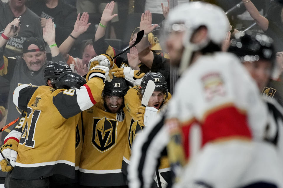Vegas Golden Knights defenseman Shea Theodore, center, celebrates his goal against the Florida Panthers with teammates during the second period of Game 1 of the NHL hockey Stanley Cup Finals, Saturday, June 3, 2023, in Las Vegas. (AP Photo/John Locher)