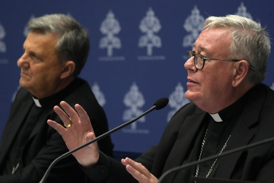 Cardinal Jean-Claude Hollerich, right, delivers his speech during a presentation of the new guidelines for the Synod of Bishops at the Vatican, Tuesday, June 20, 2023. (AP Photo/Domenico Stinellis)