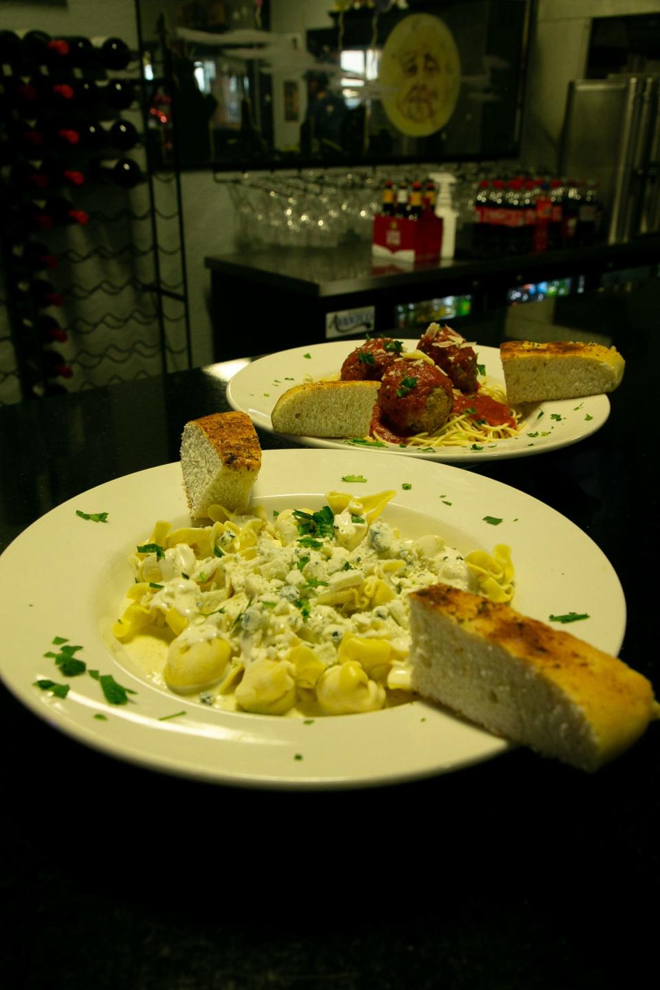 A plate of sacchetti alla gorgonzola and spaghetti marinara sit on the bar at Sal's Bronx Pizza on Wednesday, Feb. 8, 2023.