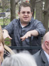 Stand up comic and actor Patton Oswalt leans on a fence as he talks to the crowd at the Ebertfest Reception at the University of Illinois Urbana-Champaign president's house in Urbana, Ill., on Wednesday, April 23, 2014. (AP PHOTO/Robin Scholz/The News-Gazette)