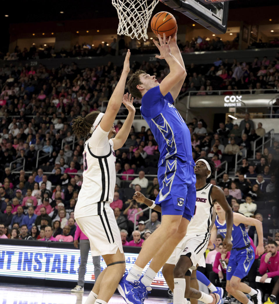 Creighton center Ryan Kalkbrenner, right, shoots next to Providence forward Josh Oduro, left, during the first half of an NCAA college basketball game Wednesday, Feb. 7, 2024, in Providence, R.I. (AP Photo/Mark Stockwell)