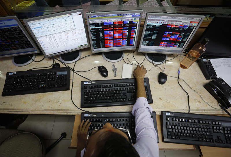 A broker monitors share prices while trading at a brokerage firm in Mumbai May 13, 2014. REUTERS/Danish Siddiqui/Files