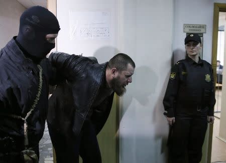 Tamerlan Eskerkhanov, detained over the killing of Boris Nemtsov, is escorted inside a court building in Moscow, March 8, 2015. Russian state investigators said on Sunday they were seeking the arrest of five suspects in the shooting of Kremlin critic Boris Nemtsov. REUTERS/Maxim Shemetov