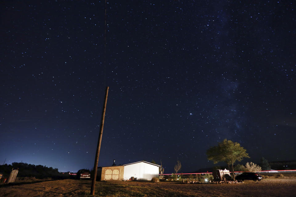 Stars fill the night sky in rural Cuba, N.M., Oct. 18 2020. The switch to remote learning in rural New Mexico has left some students profoundly isolated — cut off from others and the grid by sheer distance. The school system is sending school buses to students’ far-flung homes to bring them assignments, meals and a little human contact. (AP Photo/Cedar Attanasio)