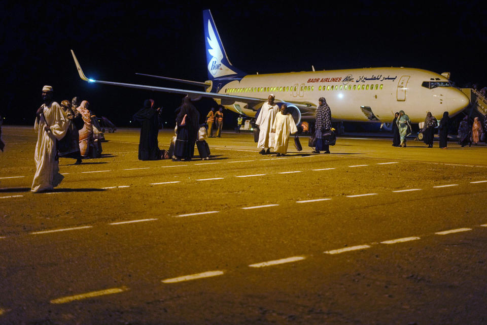 Sudanese, who had been stranded in Jeddah, Saudi Arabia, arrive at Port Sudan airport, Thursday, May 11, 2023. The conflict between the country's military and a rival paramilitary group has killed hundreds and displaced hundreds of thousands since it broke out in mid-April, creating a humanitarian crisis inside the country and at its borders. (AP Photo/Amr Nabil)