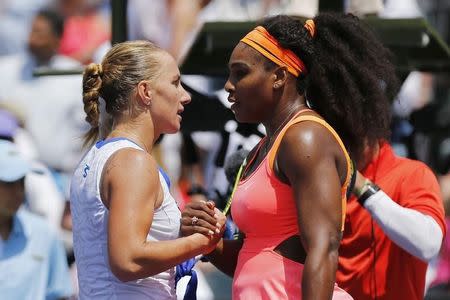 Mar 30, 2015; Key Biscayne, FL, USA; Serena Williams (L) shakes hands with Svetlana Kuznetsova (L) after their match on day eight of the Miami Open at Crandon Park Tennis Center. Williams won 6-2, 6-3. Mandatory Credit: Geoff Burke-USA TODAY