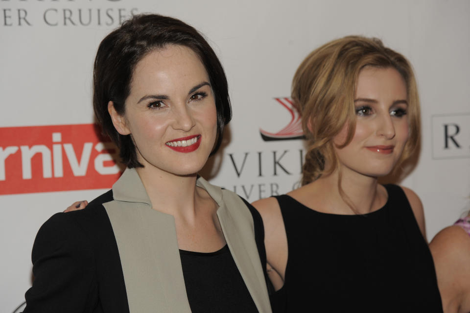 Michelle Dockery, left, and Laura Carmichael, cast members in the Masterpiece series "Downton Abbey," pose together at the PBS Summer 2013 TCA press tour at the Beverly Hilton Hotel on Tuesday, Aug. 6, 2013 in Beverly Hills, Calif. (Photo by Chris Pizzello/Invision/AP)