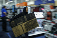 A shopper buys a TV inside Best Buy as the store opens in Newport, New Jersey November 27, 2014. REUTERS/Eduardo Munoz