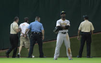 Security and Houston Police apprehend a fan that ran onto the field during a baseball game between the Pittsburgh Pirates and Houston Astros at Minute Maid Park on July 8, 2010 in Houston, Texas. (Photo by Bob Levey/Getty Images)