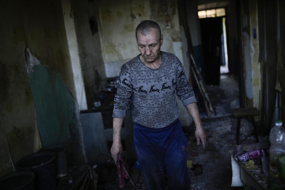 A local resident gathers belongings from his heavily damaged house after a Russian strike in Pokrovsk, eastern Ukraine, Wednesday, May 25, 2022. Two rockets struck the eastern Ukrainian town of Pokrovsk, in the Donetsk region early Wednesday morning, causing at least four injuries. (AP Photo/Francisco Seco)