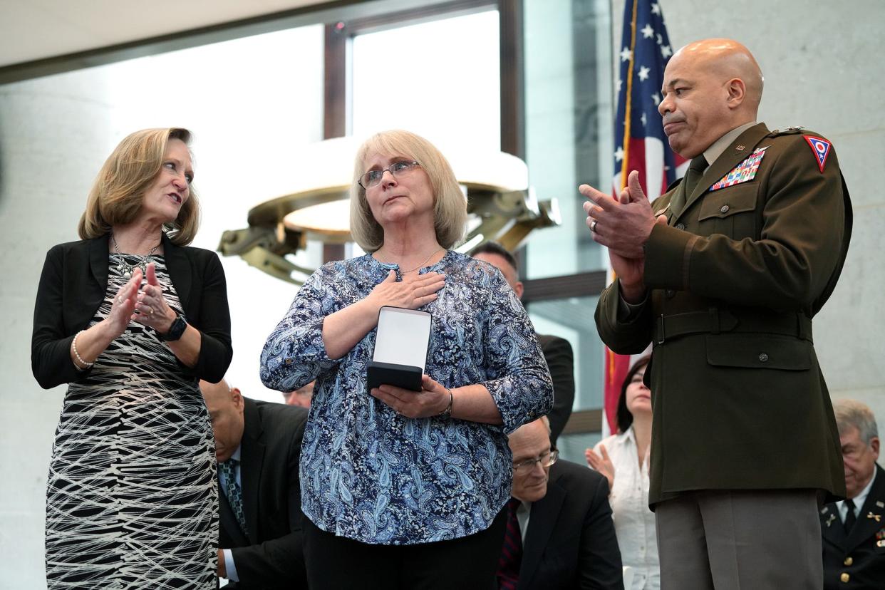 Jodi Prater, of Bellefontaine, center, represented her late brother, U.S. Army Pfc.  Herbert S. Bechtel, during the 2022 induction ceremony for the Ohio Military Hall of Fame for Valor on Friday at the Ohio Statehouse. Bechtel, of Logan County, was posthumously inducted into the Hall of Fame. Presenting the award were Ohio Army National Guard Maj. Gen. (Retired) Deborah Ashenhurst , director of the Ohio Department of Veterans Services, left, and Maj. Gen. John C. Harris, Jr., Ohio Adjutant General, who oversees command of the Ohio Army National Guard, Ohio Air National Guard, Ohio Military Reserve and Ohio Naval Militia.