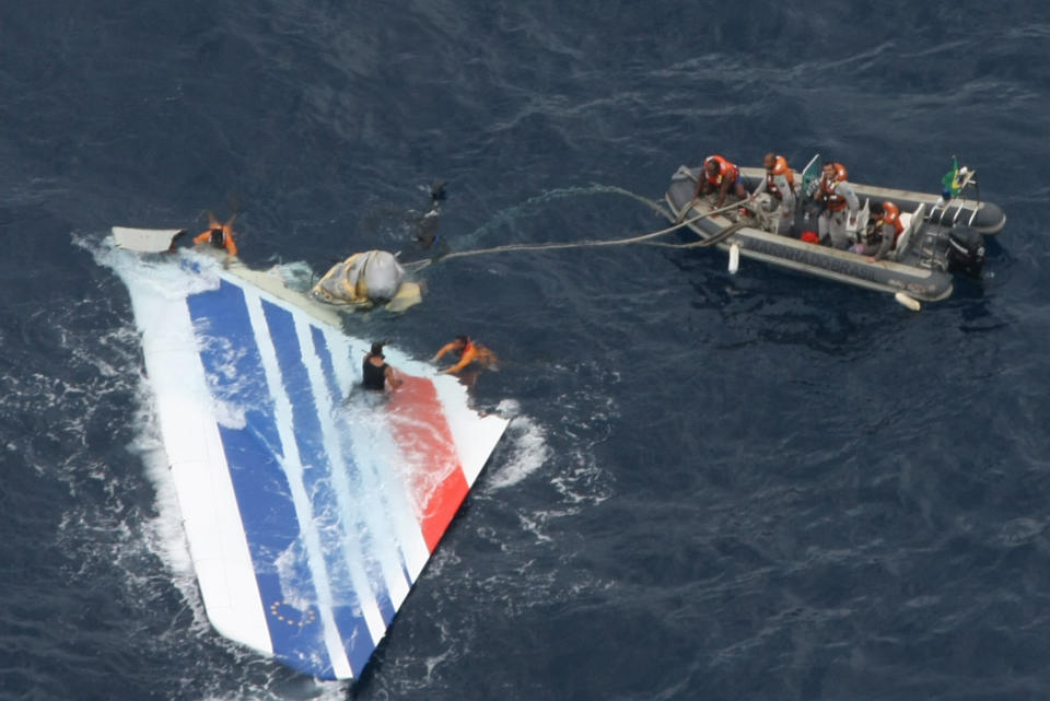 FILE - In this Monday, June 8, 2009 file photo released by Brazil's Air Force, Brazil's Navy sailors recover debris from the missing Air France Flight 447 in the Atlantic Ocean. Geoff Dell, discipline leader of accident investigation at Central Queensland University, said if the black boxes of a missing Malaysia Airlines Flight MH370 were several kilometers (miles) deep, ships might need to be almost directly over them before the signal could detect them. If found in deep water, Dell expected that unmanned submarines would be needed to retrieve them. That’s how the black box from Air France Flight 447 was retrieved in May 2011, almost two years after the Airbus A330 crashed with the loss of 228 lives. (AP Photo/Brazil's Air Force, file) NO SALES