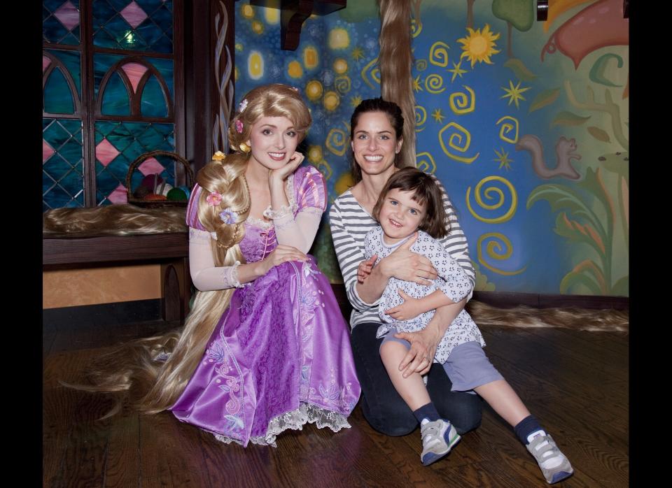 Amanda Peet and her daughter Frances Benioff meet Rapunzel from the Disney animated film, 'Tangled,' at Disneyland on January 24, 2011 in Anaheim, California.   (Photo by Paul Hiffmeyer/Disneyland via Getty Images)