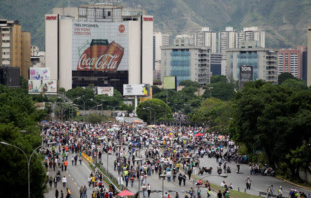 Opposition supporters block an avenue while rallying against President Nicolas Maduro in Caracas, Venezuela, May 15, 2017. REUTERS/Christian Veron