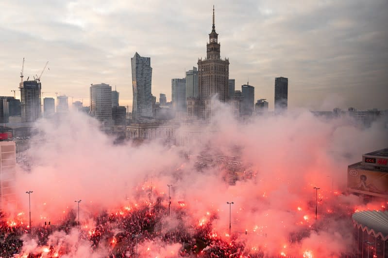 People burn flares during a march marking the National Independence Day in Warsaw