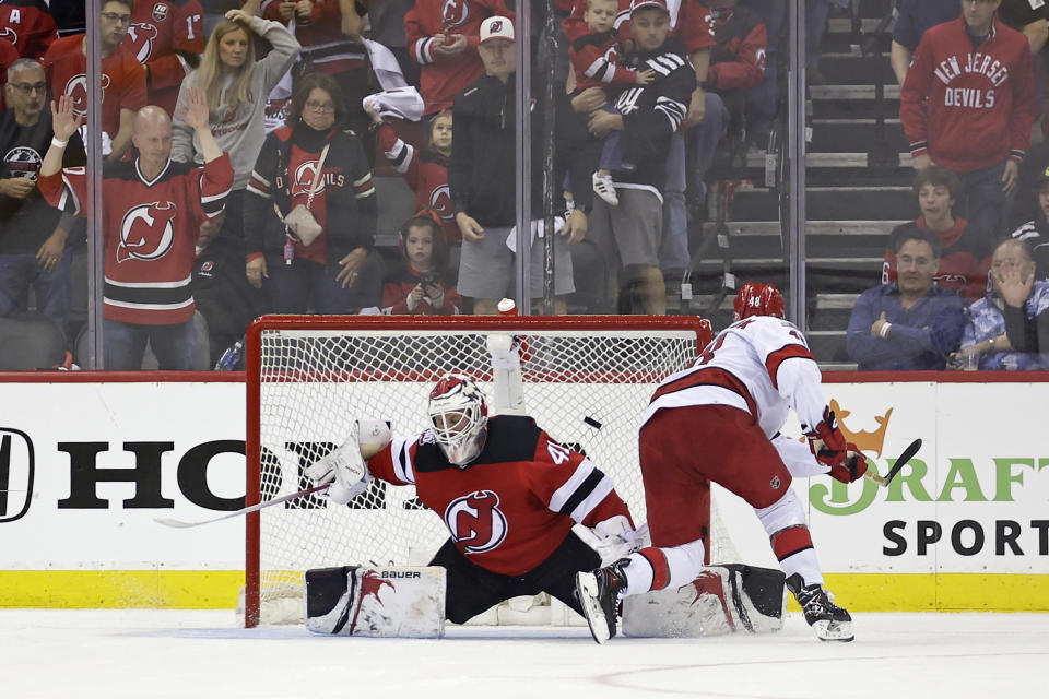 Carolina Hurricanes left wing Jordan Martinook, right, scores a penalty shot past New Jersey Devils goaltender Vitek Vanecek, left, during the second period of Game 3 of an NHL hockey Stanley Cup second-round playoff series Sunday, May 7, 2023, in Newark, N.J. (AP Photo/Adam Hunger)