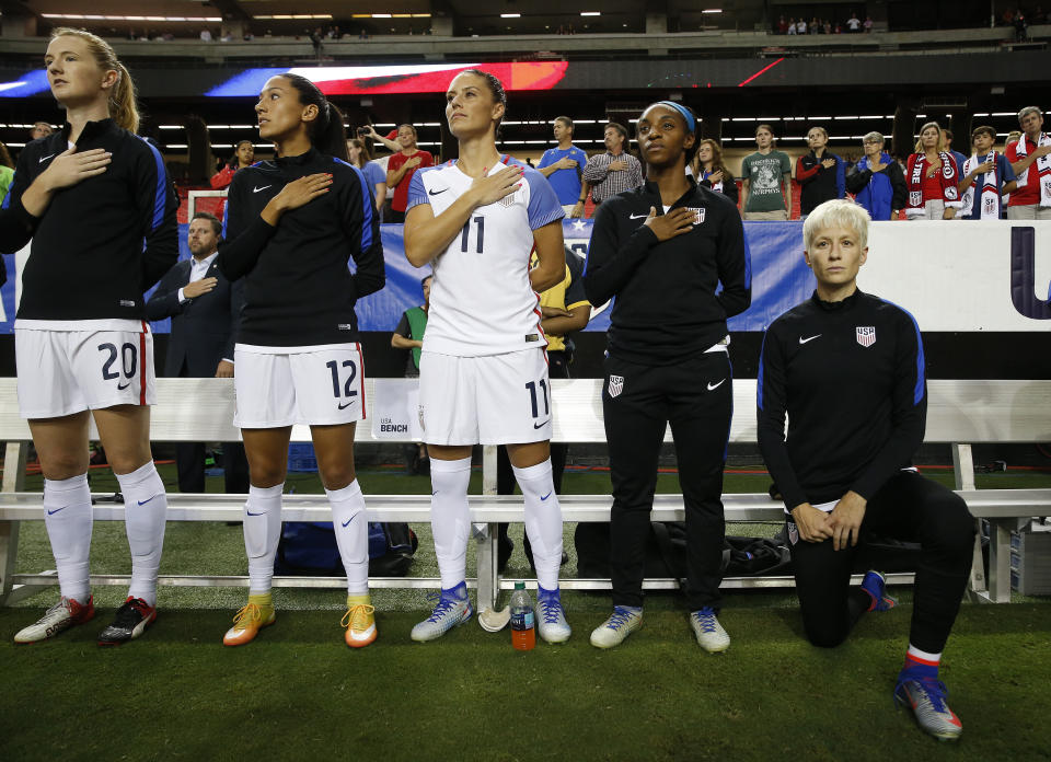 Megan Rapinoe, right, kneels next to teammates Samanth Mewis (20) Christen Press (12), Ali Krieger (11), Crystal Dunn (16) and Ashlyn Harris (22) as the US national anthem is played before an exhibition soccer match against Netherlands in 2016. (AP)