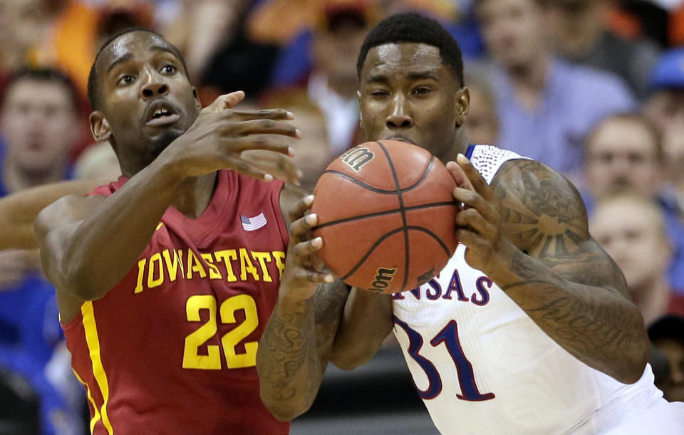 Iowa State's Dustin Hogue (22) and Kansas' Jamari Traylor (31) battle for a rebound during the first half of an NCAA college basketball game in the Big 12 men's tournament on Friday, March 14, 2014, in Kansas City, Mo. (AP Photo/Charlie Riedel)