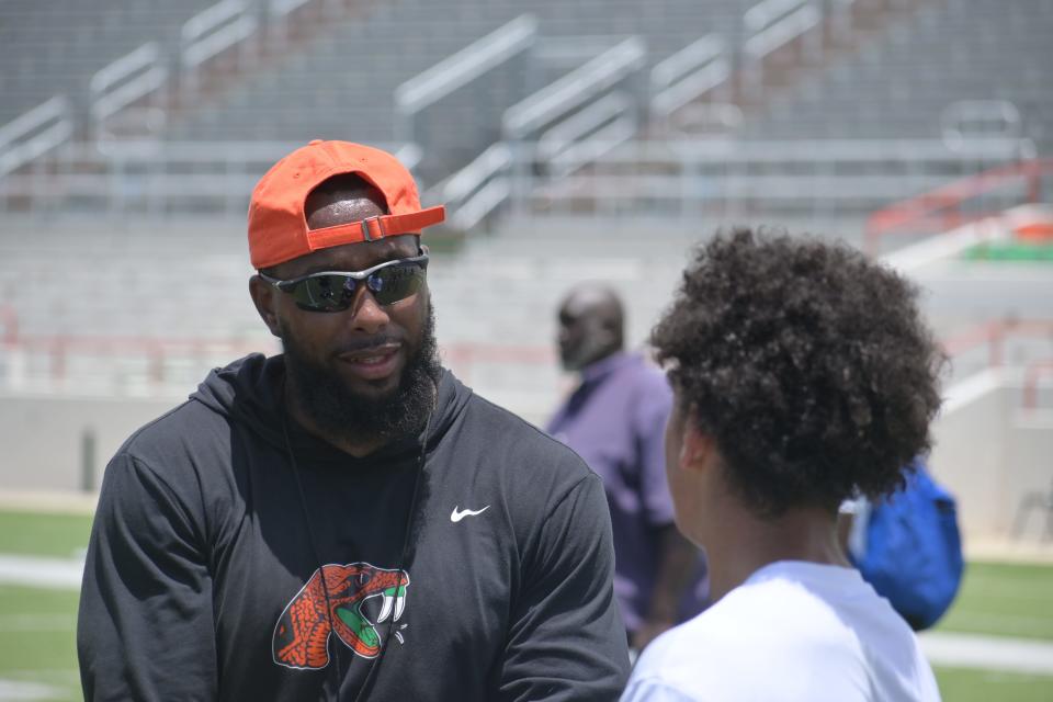 Florida A&M defensive backs coach Andre Pope coaches up campers at James Colzie III's prospect camp at Bragg Memorial Stadium in Tallahassee, Florida, Thursday, June 20, 2024.