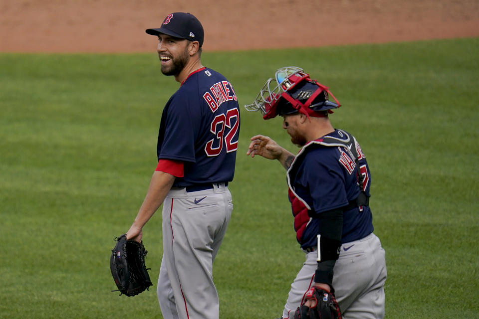 Boston Red Sox relief pitcher Matt Barnes, left, and catcher Christian Vazquez react after getting the final out of the ninth inning of a baseball game against the Baltimore Orioles, Thursday, April 8, 2021, on Opening Day in Baltimore. The Red Sox won 7-3. (AP Photo/Julio Cortez)