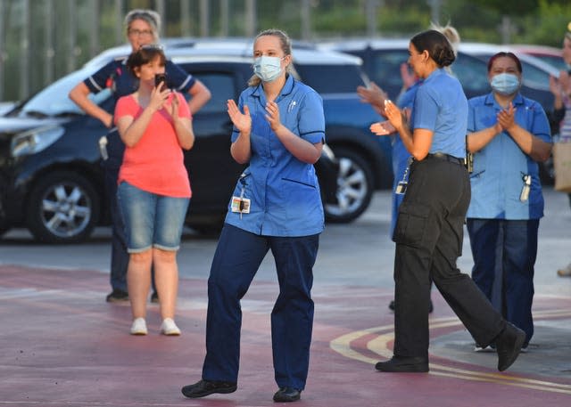 NHS staff from Queen Elizabeth Hospital in Birmingham gather as they join in the applause to salute local heroes during as nationwide Clap for Carers (Jacob King/PA)