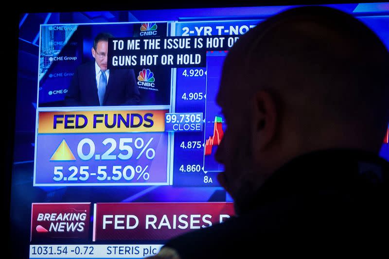 FILE PHOTO: Traders react to Fed rate announcement on the floor of the NYSE in New York