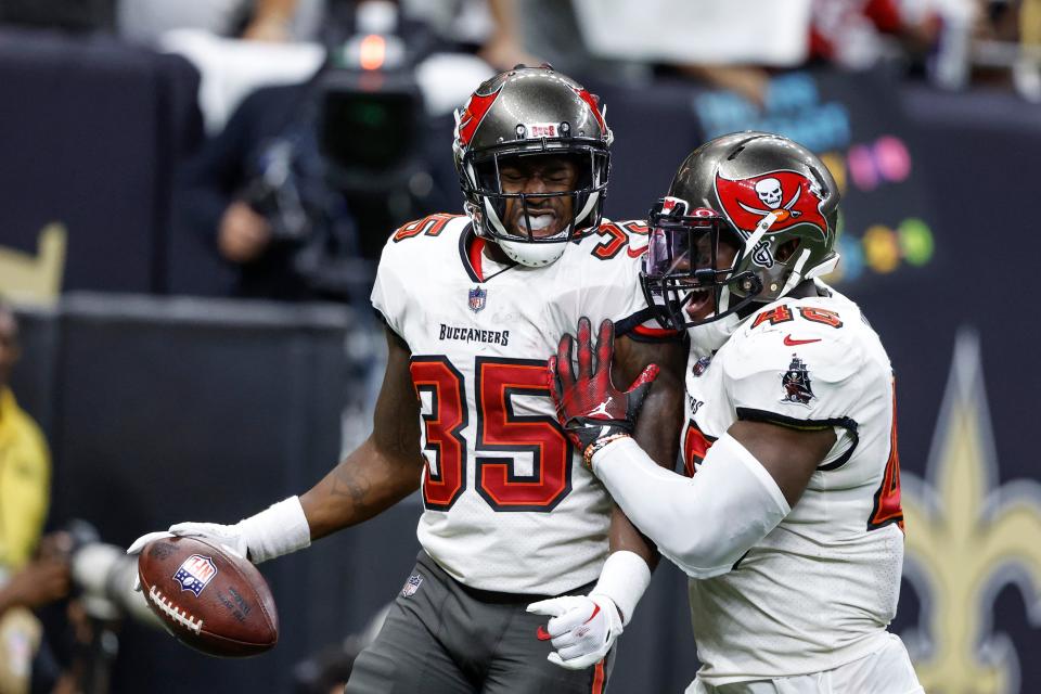 Tampa Bay Buccaneers cornerback Jamel Dean (35) celebrates with linebacker Devin White (45) after an interception against the New Orleans Saints during the first half of an NFL football game in New Orleans, Sunday, Sept. 18, 2022. (AP Photo/Butch Dill)