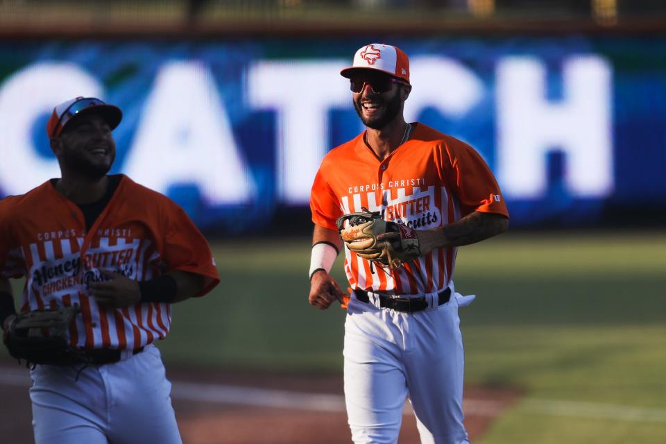 Hooks infielder Joe Perez smiles after a sliding catch from  teammate Wilyer Abreu in a game against Northwest Arkansas at Whataburger Field in Corpus Christi, Texas on Wednesday, July 13, 2022. The Hooks won 10-3.