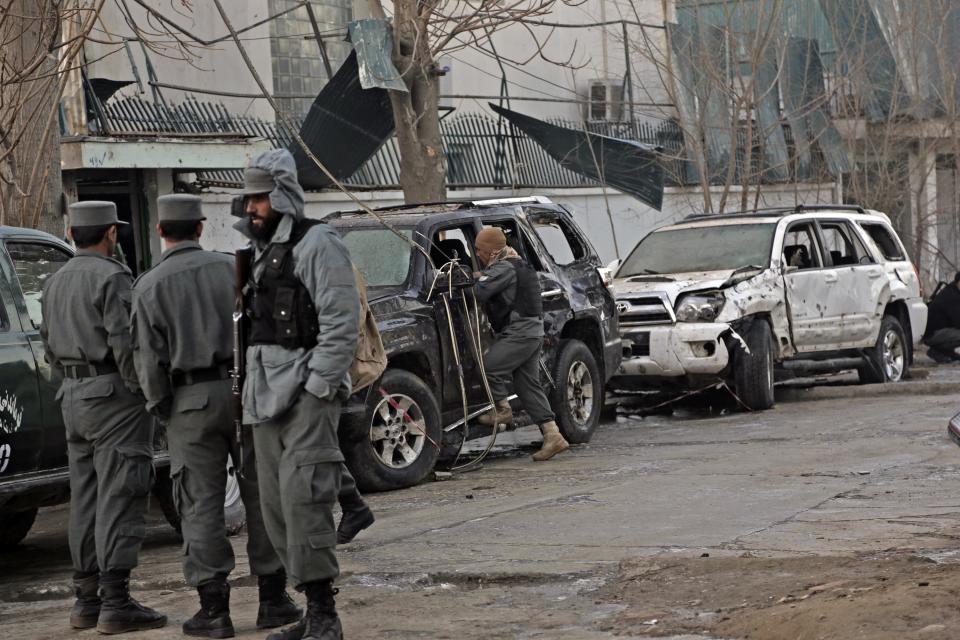 Afghan security forces personnel investigate the site of Friday's suicide attack and shooting, in Kabul, Afghanistan, Saturday, Jan. 18, 2014. A Taliban suicide bomber and two gunmen on Friday attacked a Lebanese restaurant that is popular with foreigners and affluent Afghans in Kabul, a brazen attack that left 16 dead, including foreigners dining inside and two other gunmen, officials said. (AP Photo/Rahmat Gul)