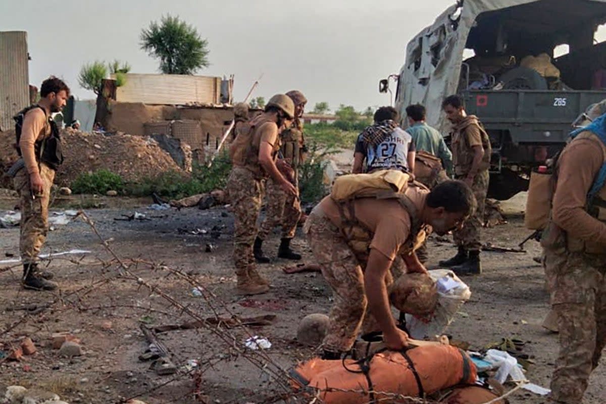 Pakistani army personnel inspect the site of a bomb attack in the Bannu district of Khyber Pakhtunkhwa province (AFP via Getty Images)