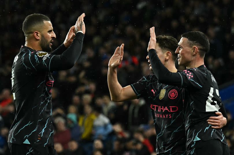 Phil Foden (R) celebrates scoring for Manchester City