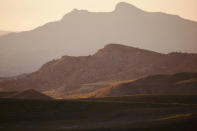 This Wednesday, June 15, 2022 photo shows hills outside Cody, Wyo. The region is ground zero in the conflict between golden eagles and wind farms, which both find homes in areas where there are strong winds. As wind turbines proliferate, scientists say deaths from collisions could drive down golden eagle numbers considered stable at best and likely to drop in some areas. (AP Photo/Emma H. Tobin)