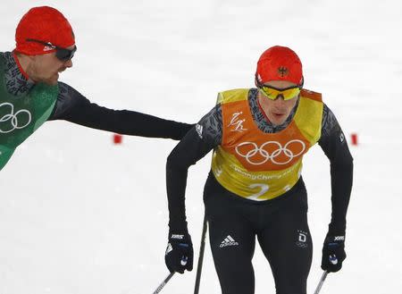 Nordic Combined Events - Pyeongchang 2018 Winter Olympics - Men's Team 4 x 5 km Final - Alpensia Cross-Country Skiing Centre - Pyeongchang, South Korea - February 22, 2018 - Fabian Riessle of Germany tags teammate Eric Frenzel. REUTERS/Dominic Ebenbichler