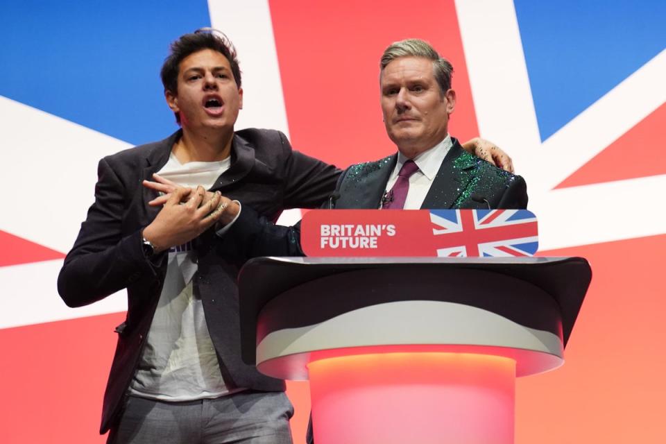 A protester throws glitter over and disrupts Labour leader Sir Keir Starmer (PA Wire)