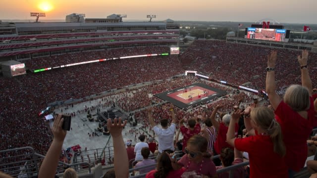 Volleyball fans cheer during during a college volleyball match between University of Nebraska and Omaha at Memorial Stadium