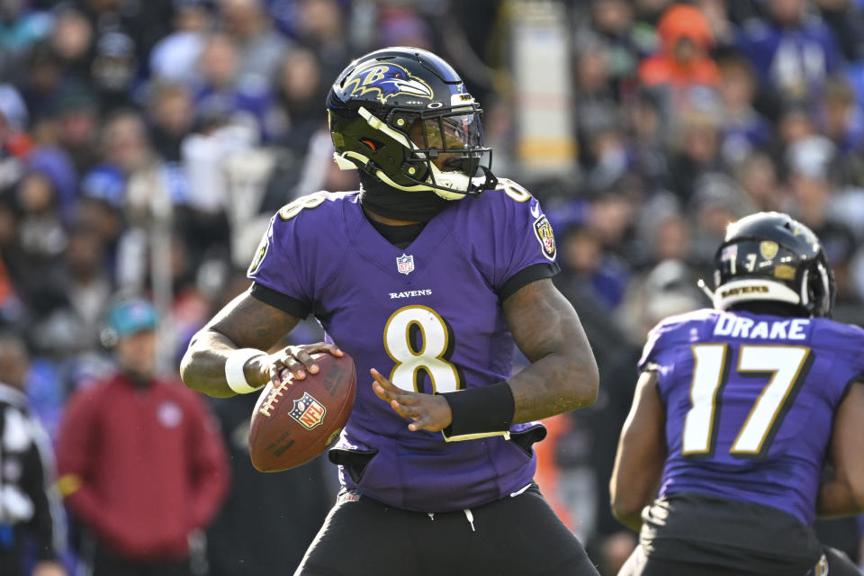FILE - Baltimore Ravens quarterback Lamar Jackson (8) looks to pass the ball during the first half of an NFL football game against the Denver Broncos, Sunday, Dec. 4, 2022, in Baltimore. Lamar Jackson was again absent from practice during the portion open to reporters Wednesday, Jan. 11, 2023. The Baltimore star hasn't practiced since injuring his knee in a Dec. 4 win over Denver, and there was no sign of him Wednesday as the Ravens prepared for Sunday night's playoff opener at Cincinnati. Jackson missed the final five games of the regular season.(AP Photo/Terrance Williams, File)