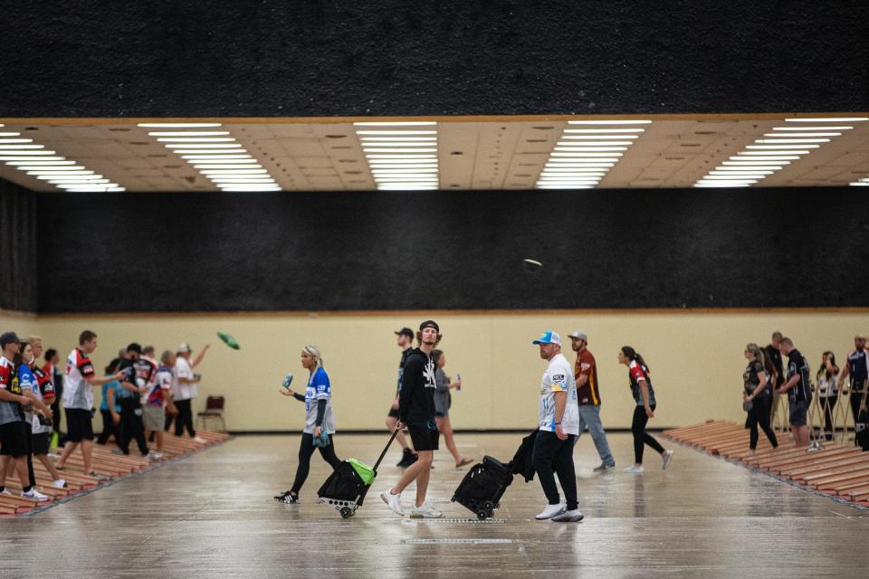 Bags fly across the American Bank Center during the American Cornhole League Kickoff Battle tournament on April 8, 2023, in Corpus Christi, Texas. About 300 competitors compete over the summer season for prize money.