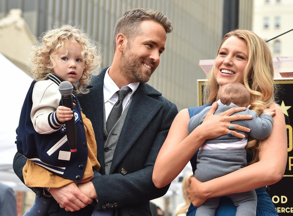 Blake and Ryan hold two of their children at an event