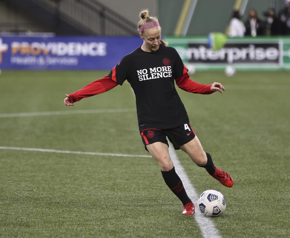 Portland Thorns defender Becky Sauerbrunn wears a warmup jersey before the team's NWSL soccer match against the Houston Dash in Portland, Ore., Wednesday, Oct. 6, 2021. Players stopped on the field during the first half of Wednesday night's National Women’s Soccer League games and linked arms in a circle to demonstrate solidarity with two former players who came forward with allegations of sexual harassment and misconduct against a prominent coach. (AP Photo/Steve Dipaola)