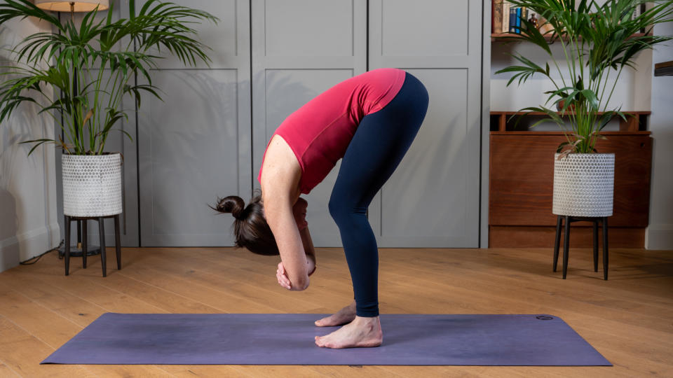 Woman performing standing forward fold