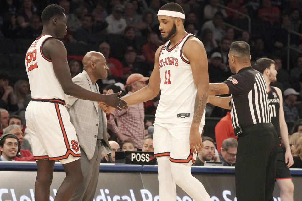 St. John's forward Esahia Nyiwe, left, replace teammate Joel Soriano, center, after he fouled out during the second half of an NCAA college basketball game against UConn Saturday, Feb. 25, 2023, in New York. (AP Photo/Bebeto Matthews)