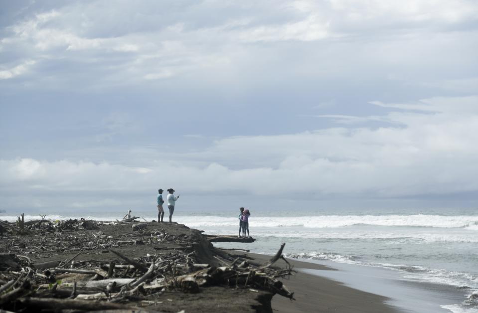 CORRECTS SPECIES OF TURTLES - In this Sept. 22, 2019 photo, people visit a beach where olive ridley sea turtle lay their eggs, in Jaque, Panama. Jaque, a town of 2,000, is only reached by air or sea. (AP Photo/Arnulfo Franco)