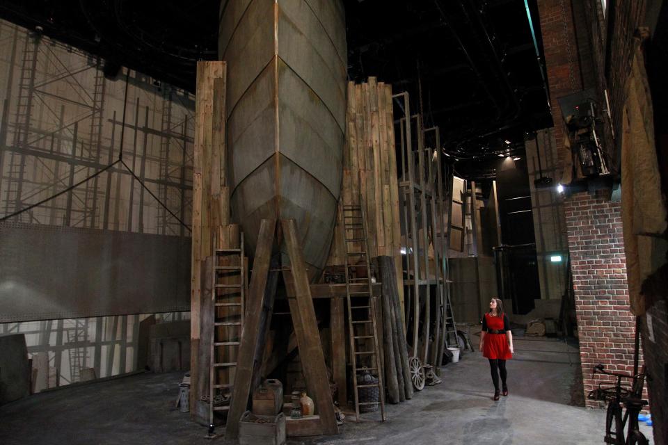 In this photo of Tuesday March 13, 2012 a woman looks at the hull of a ship in the Cave area of the new 100 million British pounds ($157 million)Titanic Belfast Visitor's Center. Celebrating the ship and the people who built her is the aim of Titanic Belfast, a shiny new "visitor experience" _ don't call it a museum _ whose four prow-like wings jut jauntily skyward beside the River Lagan on the site of the old Harland and Wolff shipyard. Titanic, the world's largest, most luxurious ocean liner, left this spot on April 2, 1912 on its maiden voyage from England to New York. Twelve days later, it stuck an iceberg off the coast of Newfoundland and sank in the early hours of April 15. More than 1,500 of the 2,200 people on board died. (AP Photo/Peter Morrison)