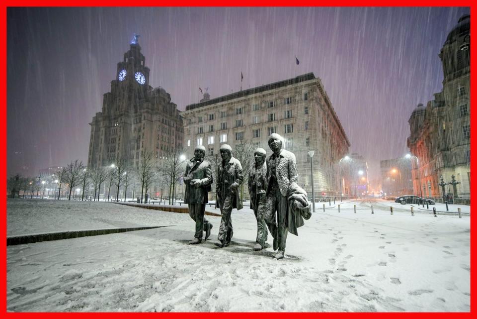 Snow falls on the Beatles Statue at Pier Head, Liverpool, on Tuesday (Peter Byrne/PA Wire)